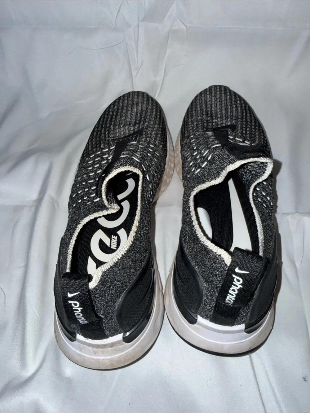 Nike women’s Black and Gray Knit Slip-On Sneakers